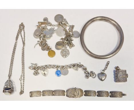 Hollow silver bangle, a silver charm bracelet, various charms, etc 
