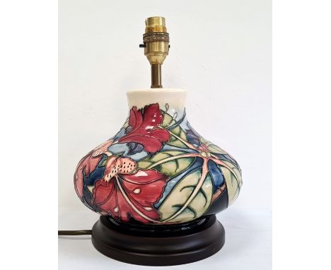 Moorcroft pottery table lamp, squat baluster shape and having tube-lined hibiscus decoration, stepped wooden base, 18cm high 