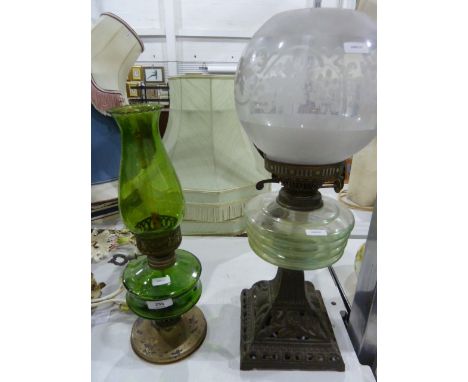 Paraffin lamp with a clear glass bowl, supported on a decorative metal single-column base with a glass shade, another with gr