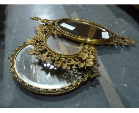 Three various gilt-framed mirrors, a pair of brass mirrored electric light sconces, a another pair of brass electric light sc