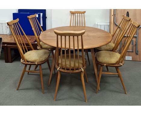 Light elm Ercol drop-leaf table raised on beech supports and a set of six Ercol light elm seated and beech comb-back dining c