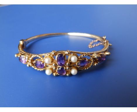 An amethyst & pearl set 9ct gold bangle.