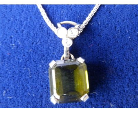 A tourmaline & diamond pendant on necklace chain.