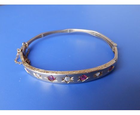 A gypsy set ruby & diamond bangle – 9ct.