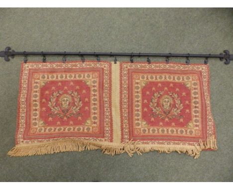 A small 20thC tapestry hanging on metal pole.
