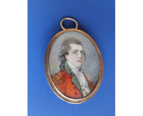 A Georgian memorial pendant with plaited hair panel and enamelling to one side (glass broken) and a crudely painted portrait 