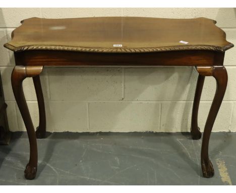 20th century mahogany lamp table, with shaped top raised on claw and ball supports, 106 x 50 x 77 cm H, wear and heat mark to