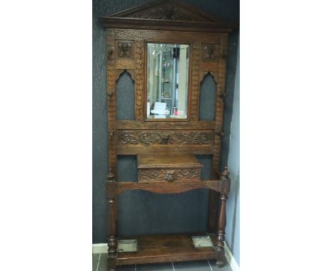 Victorian profusely carved hall stand with six hat pegs, glove box and stick stand, W: 92 cm, H: 210 cm. Not available for in