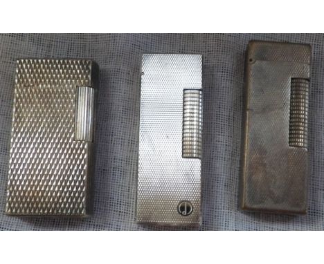 THREE ENGINE TURNED CIGARETTE LIGHTERS