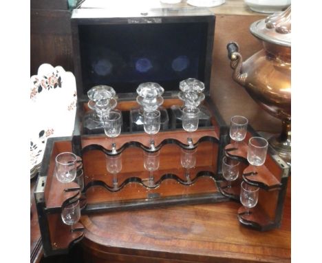 A 19TH CENTURY THREE BOTTLE DECANTER BOX, a folding front fitted to hold glasses, fitted with a Bramah lock