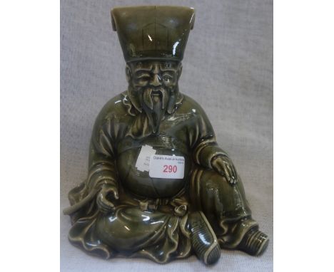 A JAPANESE GREEN GLAZED CERAMIC FIGURE, modelled seated, signed character marks, 21cm high