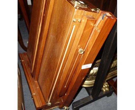 AN ARTIST'S FOLDING EASEL with integral paint box and contents