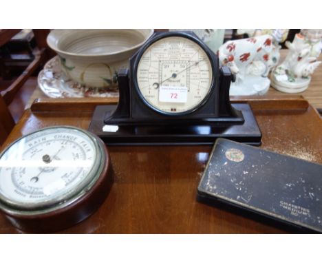 A 1930'S ART DECO BAKELITE CASED 'STORMOGUIDE' DESK BAROMETER, another barometer and a Player's cigarettes tin