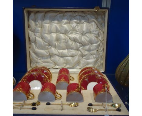 A CASED SET OF ROYAL WORCESTER COFFEE CANS AND SAUCERS, painted with polychrome enamels and gilt-highlights on a red ground, 