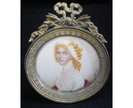 A MINIATURE HEAD AND SHOULDERS OF A LADY, in a gilt frame with easel back