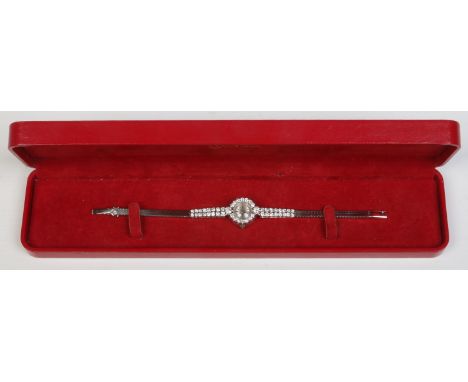 A ladies Art Deco Omega white metal and diamond manual cocktail watch in case. Having satin dial and baton markers. With diam