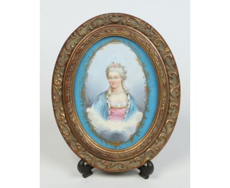 A late 19th century oval Sevres style plaque in gilt frame. Blue ground and painted with the portrait of a noblewoman, 19cm x