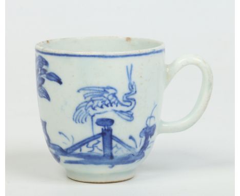 An early Bow coffee cup with loop handle. Painted in underglaze blue in the Chinese style with a bird perched on a fence in a