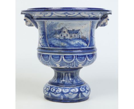 A 19th century Continental faience blue and white pedestal jardiniere. With moulded lion mask handles, painted with a hunting