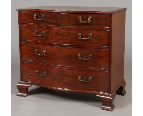 A George III mahogany two over three serpentine chest of drawers. With ormolu rococo style handles and raised on ogee bracket