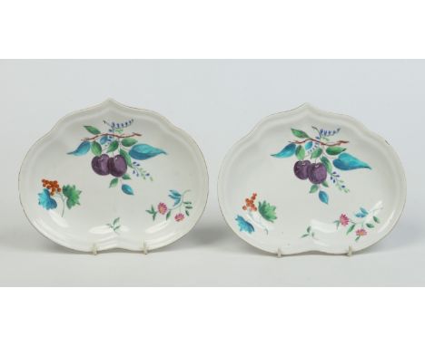 A pair of Derby kidney shaped dessert dishes with gilt rims. Outside decorated with polychrome enamels depicting fruit and fl