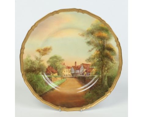 A Royal Worcester cabinet plate by Harry Ayrton. With a tooled gilt border and painted with a named view of Tewkesbury. Signe