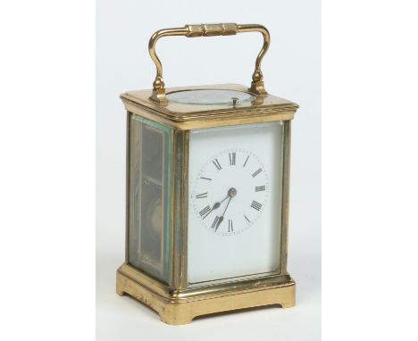 A brass cased carriage clock with enamel dial, having repeater mechanism and striking on a gong, 18cm.   Condition Report. To