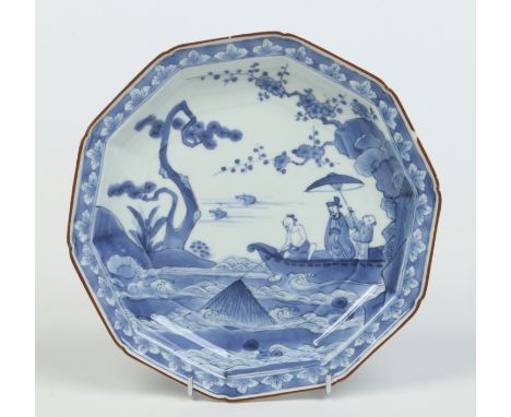 A late 17th century Japanese decagonal blue and white dish with brown enamel rim, probably Kakiemon kiln. Painted with fisher