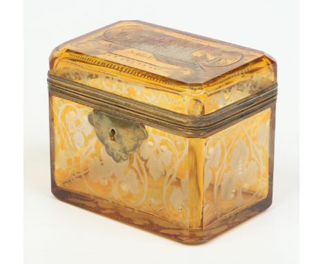 A 19th century Bohemian etched amber glass casket with gilt metal mounts. Decorated to the hinged cover with a castle and ins
