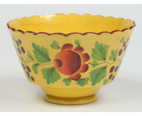 An early 19th century yellow ground English pottery sugar bowl with fluted rim edged in brown enamel. Decorated with trailing