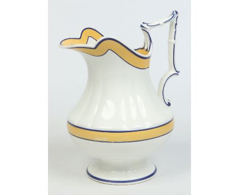 A large 19th century Wedgwood creamware jug with reeded moulding. Painted with blue and yellow enamel banding. Impressed mark