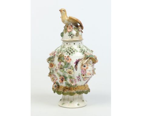 A Derby ovoid potpourri vase and cover. Moulded with a bird finial, twin mask handles and adorned with applied flowers. Paint