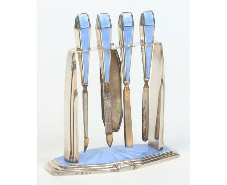 A George V Art Deco silver manicure set on stand by Adie Brothers Ltd. Decorated with blue guilloche enamel. Assayed Birmingh