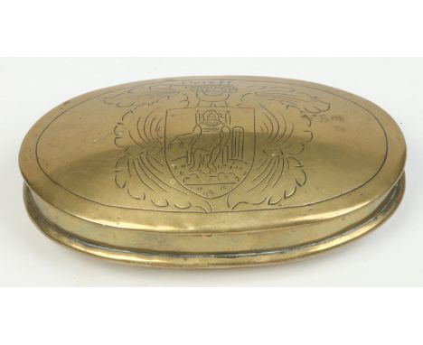 An 18th century Dutch oval brass snuff box with incised decoration depicting a knight within a shield cartouche, 13cm wide.