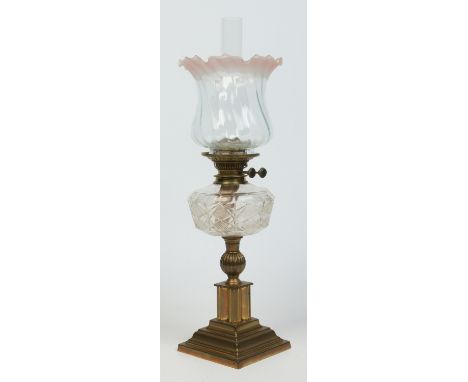 A Victorian brass based oil lamp with cut glass font, 64cm.   Condition Report. To be used as a guide only.  Shade decoration