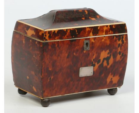 A Regency tortoiseshell tea caddy, fitted with two compartments and raised on ball feet, 15.5cm wide.   Condition Report. To 