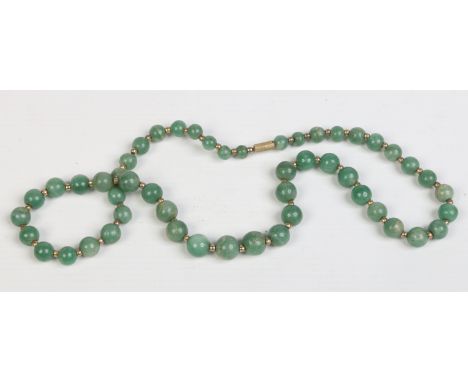 A string of graduated mottled celadon jade beads, 58cm.