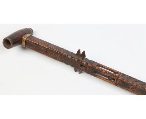 A 19th century Welsh folk art carved walking stick / pipe stick. The hinged handle formed as a pipe an inscribed to the shaft