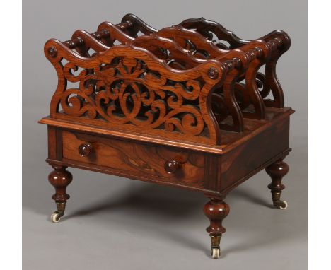 A William IV rosewood Canterbury. With open fretwork dividers, single drawer and raised on turned baluster supports, 51cm wid
