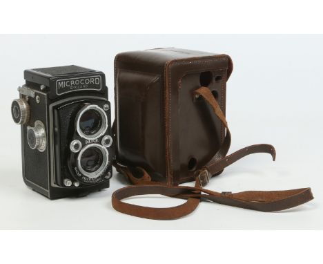 A Micro Precision Products twin reflex lens Microcord camera in fitted leather case and with Ross 77.5mm lenses numbers 62670