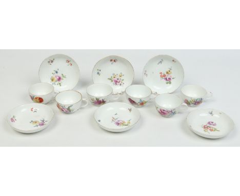 Six Meissen Marcolini period teacups and saucers painted in coloured enamels with flowers. Underglaze crossed swords marks.  
