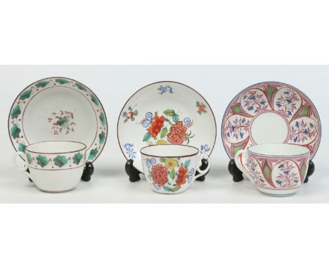 Three Newhall teacups and saucers decorated in coloured enamels. One with trailing ivy, one with lustre panels and the other 