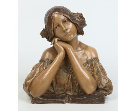 An Austrian Goldscheider style Art Nouveau glazed terracotta bust of a young wistful girl. Impressed mark and signed Doebrich