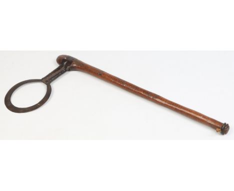 An antique tribal axe with leather mounts. Having unusual circular open blade with engraved detail, the shaft incised with tr