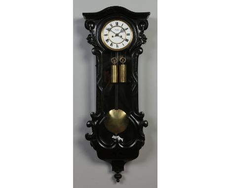 A 19th century ebonized Vienna wall clock. With enamel dial signed Suchy, housing a twin train 8 day movement striking on a g