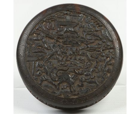 An early 19th century Chinese carved tortoiseshell circular snuff box and cover. Decorated to the cover with hunting scenes a