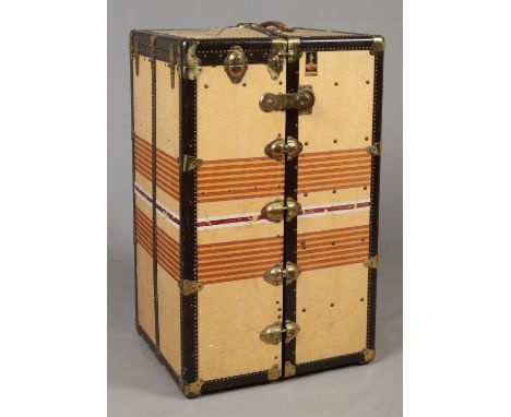 An Oshkosh Trunks Inc.  fitted travelling cabin trunk. With orange banded yellow canvas and leather mounts, monogramed G. H. 