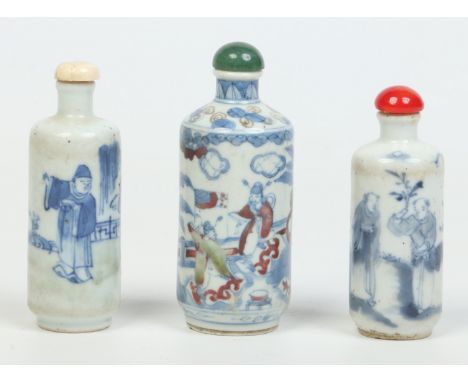 Three 19th century Chinese snuff bottles decorated in underglaze blue and copper red. With jade, ivory and glass stoppers, th