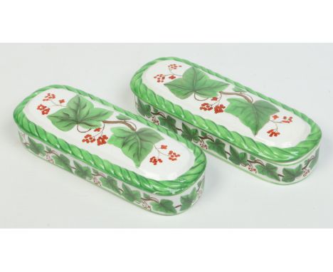 A pair of Davenport razor boxes. With rope twist moulding and decorated in print and enamel with ivy leaves and berries. Impr