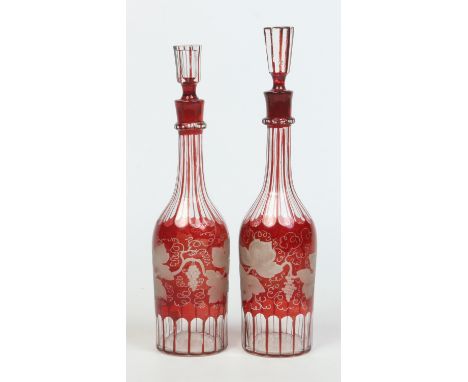 Two etched ruby flash glass carafes and stoppers, largest 35.5cm.    Condition Report. To be used as a guide only.  Good cond